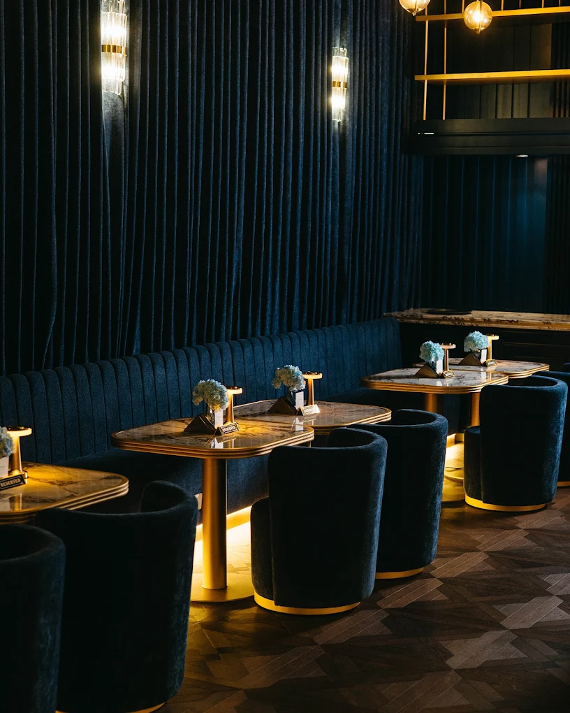 Deep blue banquettes and brass lights