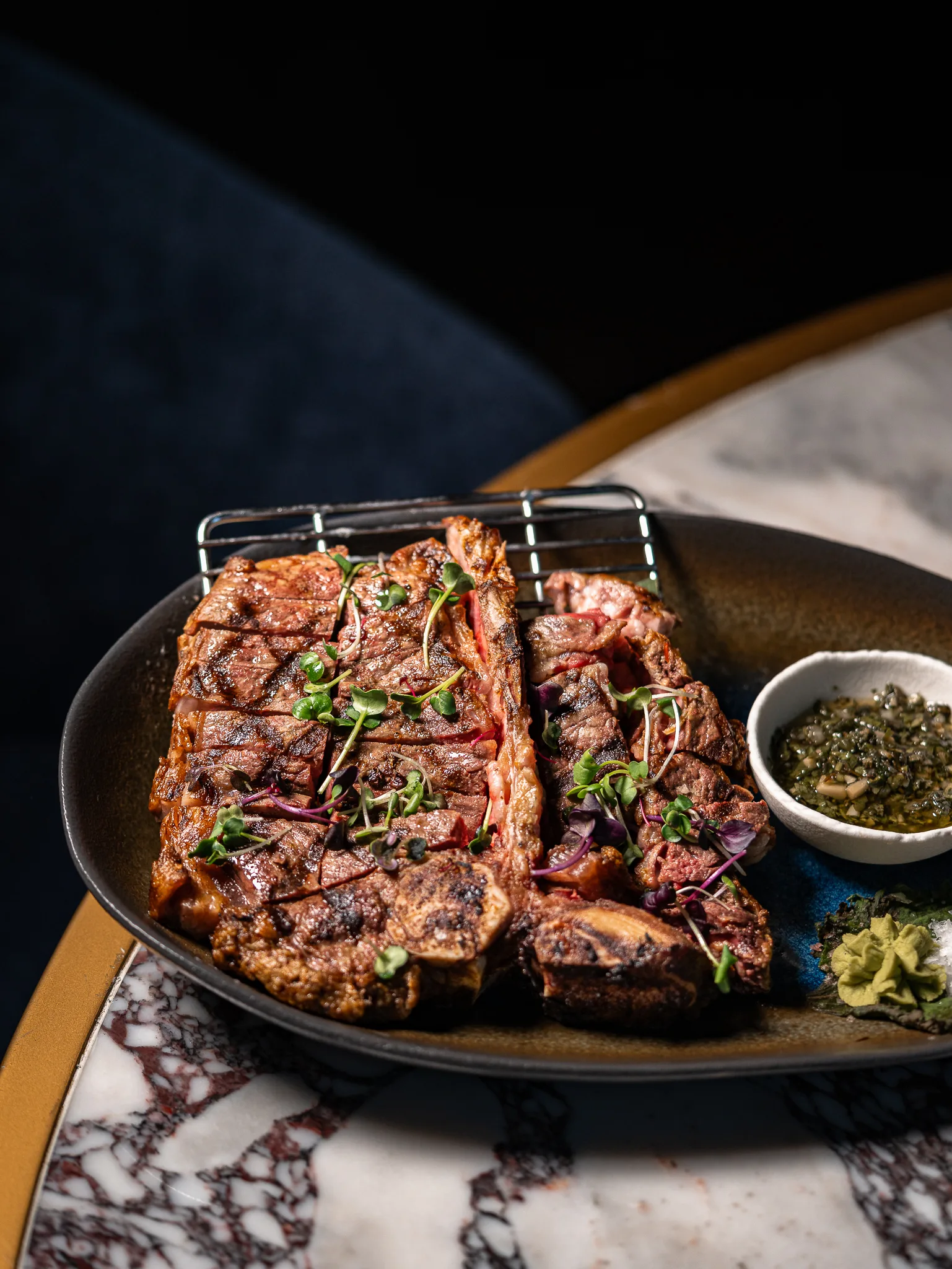 Yana Parilla T-Bone - Grilled angus , rested and carved, served with fresh wasabi, sea salt and vibrant chimichurri.